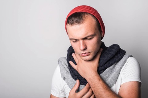 Man with closed eyes suffering from cough