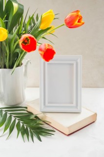 Flowers vase frame placed table near wall