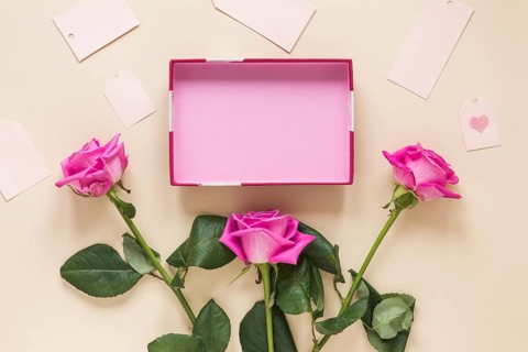 Pink rose flowers with empty box table