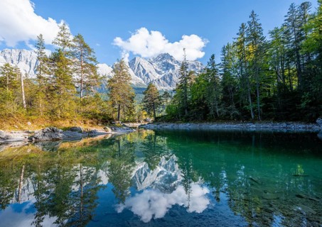 Zugspitze massif and Zugspitze reflected in Eibsee lake