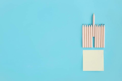 Blank sticky note with rows colored pencil blue background