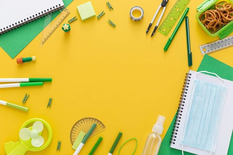 Flat lay back school materials with notebook face mask