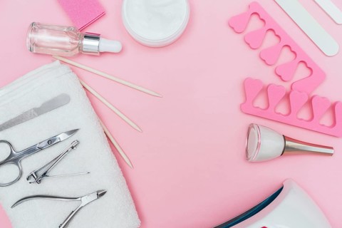 Nail care accessory tools copy space pink background