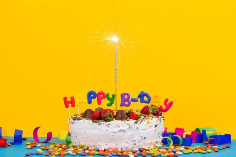 Front view birthday cake with sparkler