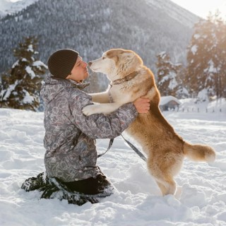 Full shot man playing with dog