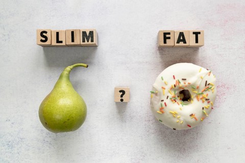 Glazed donut pear slim fat text with question mark wooden block concrete surface