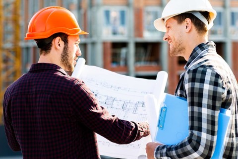 Close up back view engineer architect supervising construction