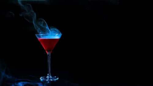 Wineglass with red smoky liquid