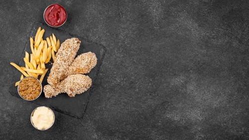 Flat lay fried chicken with french fries sauces