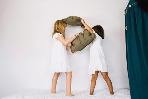 Girls fighting with pillows