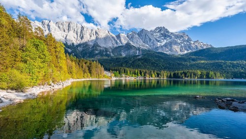 Zugspitze massif and Zugspitze reflected in Eibsee lake