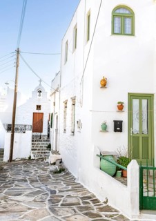 White Cycladic houses with green windows and doors