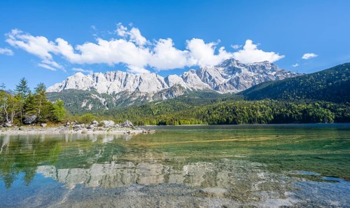 Zugspitze massif and Zugspitze reflected in Eibsee lake