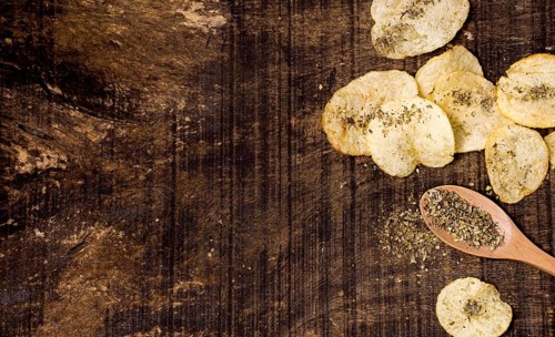 Top view potato chips with copy space spices
