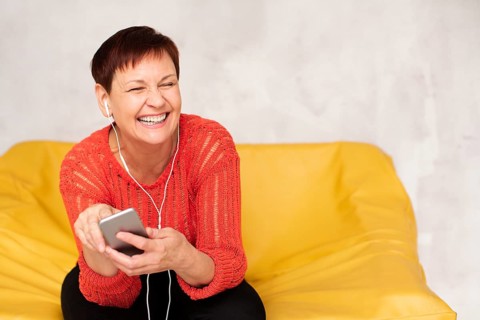 Copy space elder woman listening music