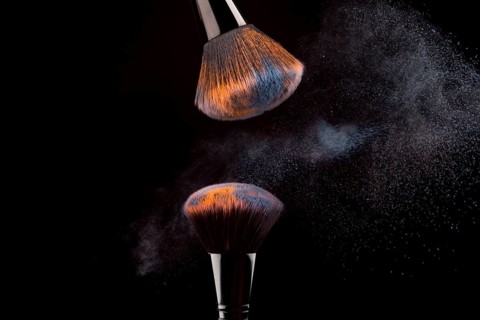 Cosmetic brushes with mist powder dark background