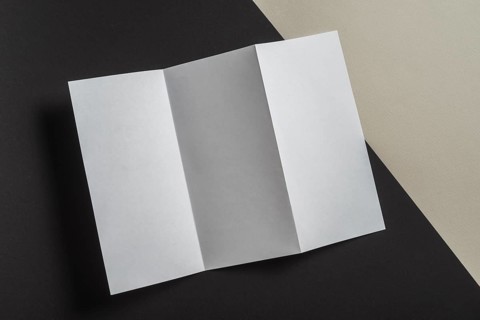 Elevated view folded white paper brochure