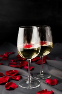 Valentine s day rose petals with wine glasses