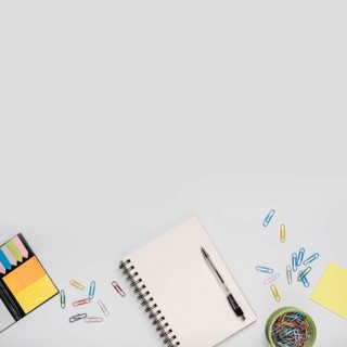 Colorful paper clips spiral notebook with pen adhesive notes white background