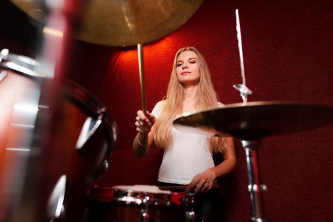 Low view shot girl playing cymbals