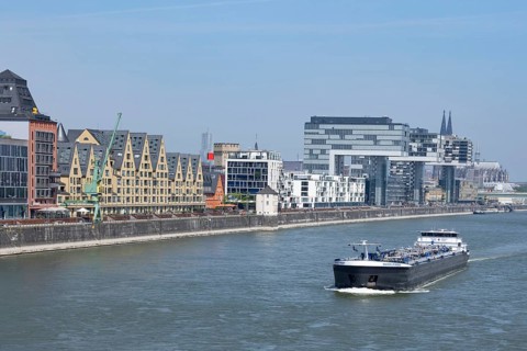 Cargo ship on the Rhine in front of Cologne's Rheinauhafen