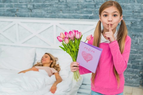 Daughter with tulips greeting card holding finger lips