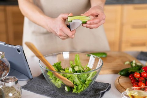 Hands cutting cucumber kitchen