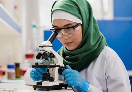 Female scientist with hijab microscope laboratory