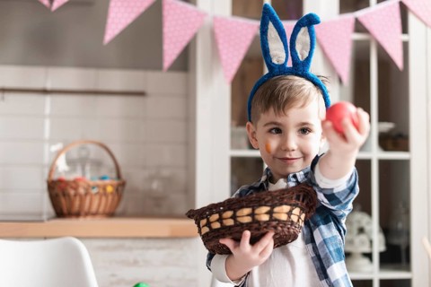 Portrait cute young boy holding easter egg