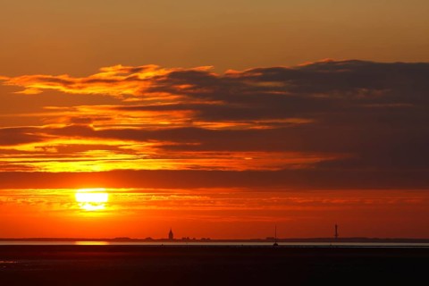 View from the island of Minsener Oog to Wangerooge at sunset