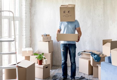 Man with box head while packing move