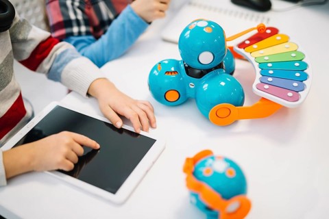 Close up boy touching digital tablet screen white desk