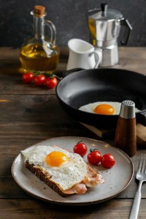 Tasty breakfast with egg bacon high angle