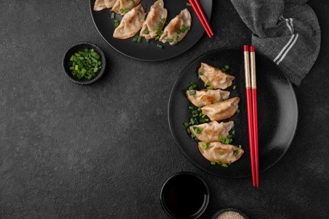 Top view asian dumplings dish with herbs