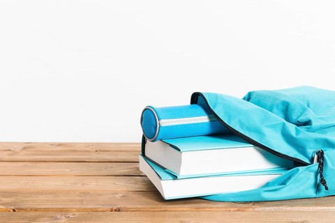 Blue books pencils case opening schoolbag wooden table