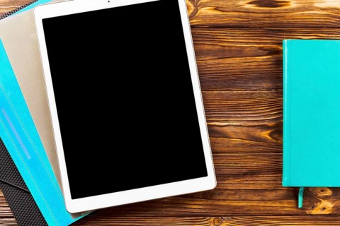 Notebook near tablet folders