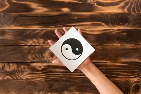 Top view hand holding ying yang symbol