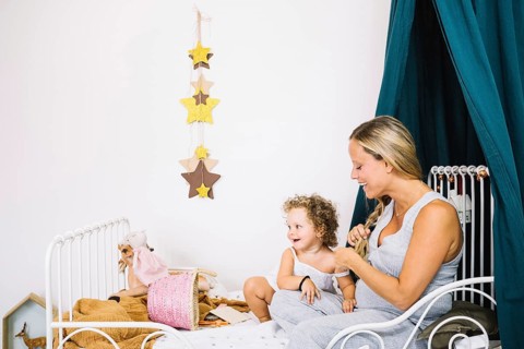 Cheerful pregnant mother baby bed