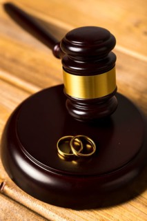 Close up with judge gavel stand with wedding rings
