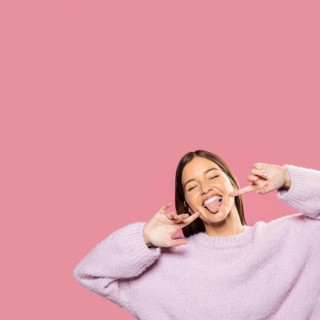 Beautiful young woman posing with pink wallpaper back