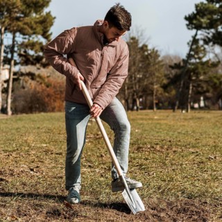 Man using shovel dig hole planting tree