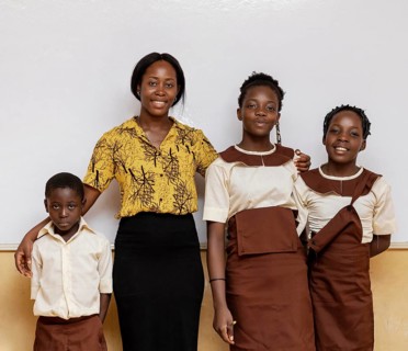 African woman teaching children class