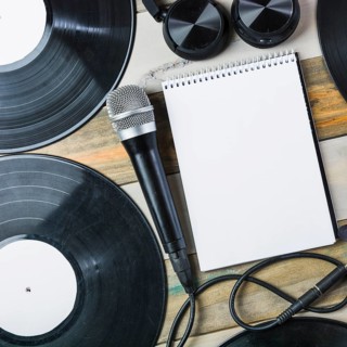 Headphone microphone vinyl record blank spiral notepad wooden table