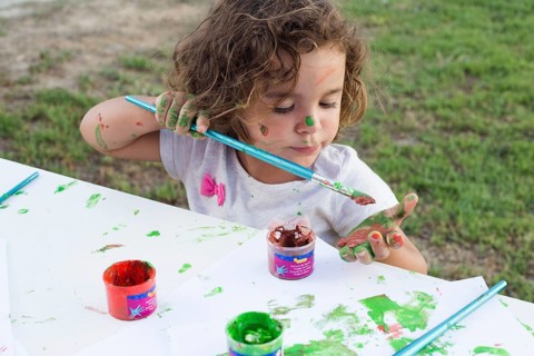 Messy girl painting canvas park