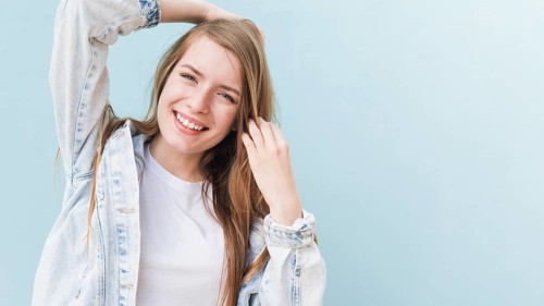 Portrait smiling attractive woman blue wall