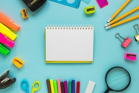 Writing implements laid circle with jotter middle