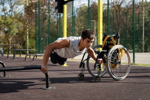 Full shot disabled man doing push ups