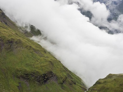 Morning fog drifts over a mountain ridge