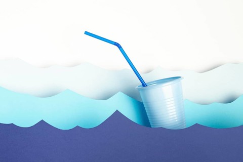 Front view plastic cup with straw paper waves