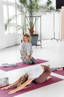 Full shot woman yoga mat stretching